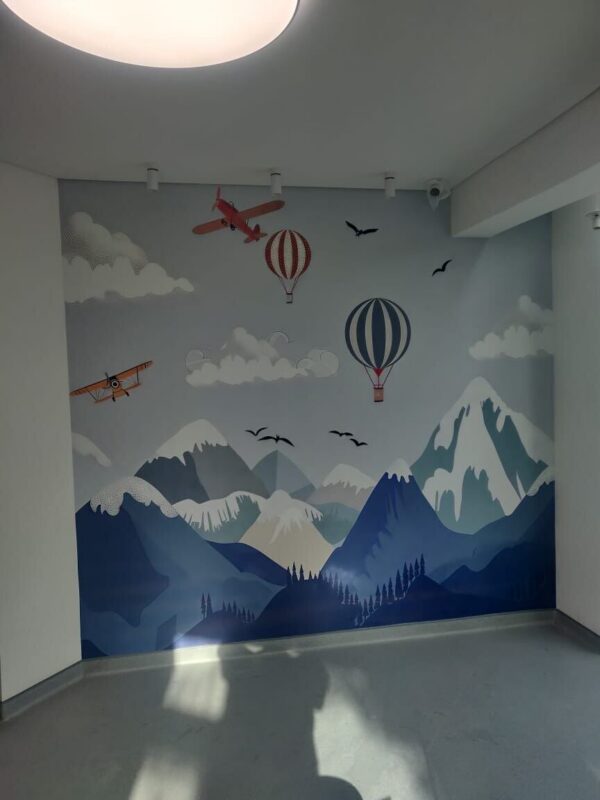 Hot air balloon and mountains custom mural wallpaper installed in a Lebanon nursery